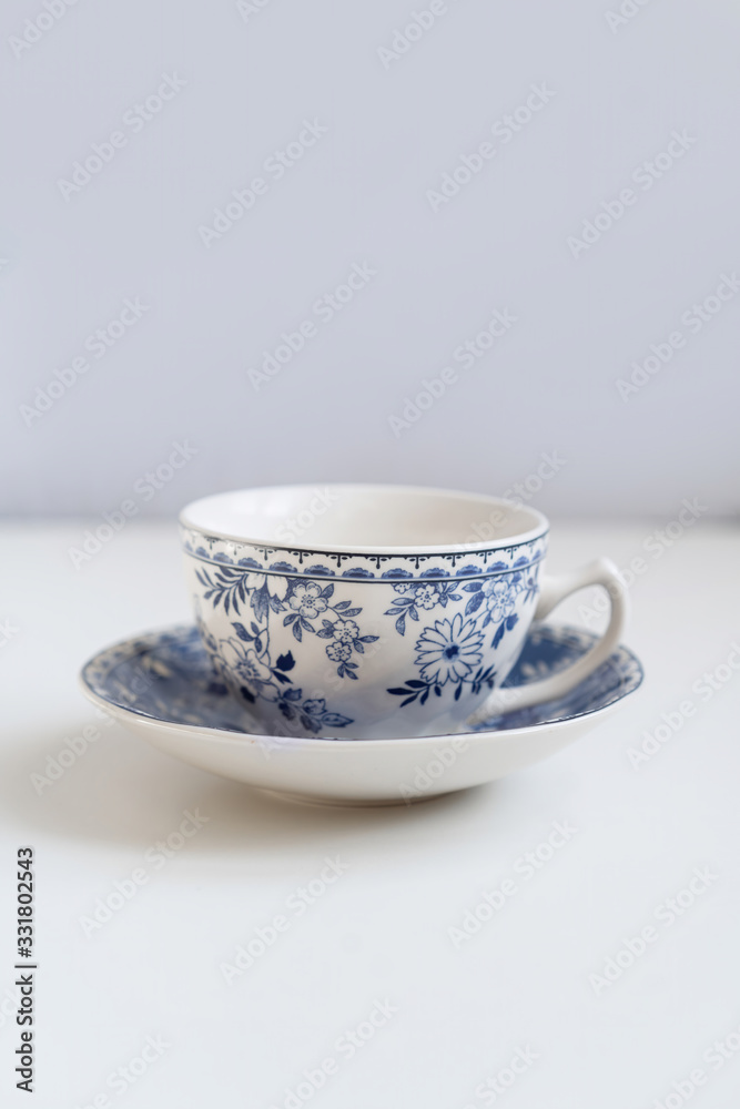 Porcelain saucers with a cup for tea in blue with flowers. New luxury elegance dinnerware on isolated white background. Trendy plate. Flat lay view. Porcelain saucers with a cup for tea in blue with flowers. New luxury elegance dinnerware on isolated white background. Trendy plate. Flat lay view.