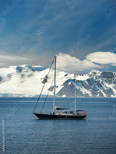 yacht in sunny day in lagoon in Antarctica