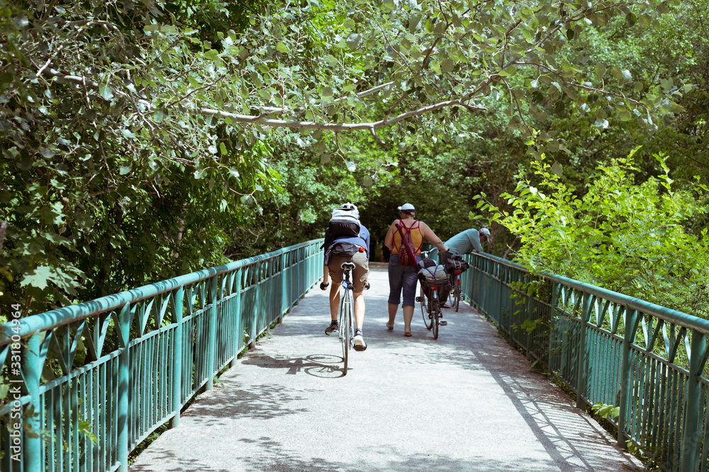 A man rides a bridge on a bicycle A man rides a bridge on a bicycle