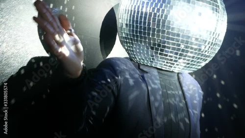 dj dancing with disco ball on his head