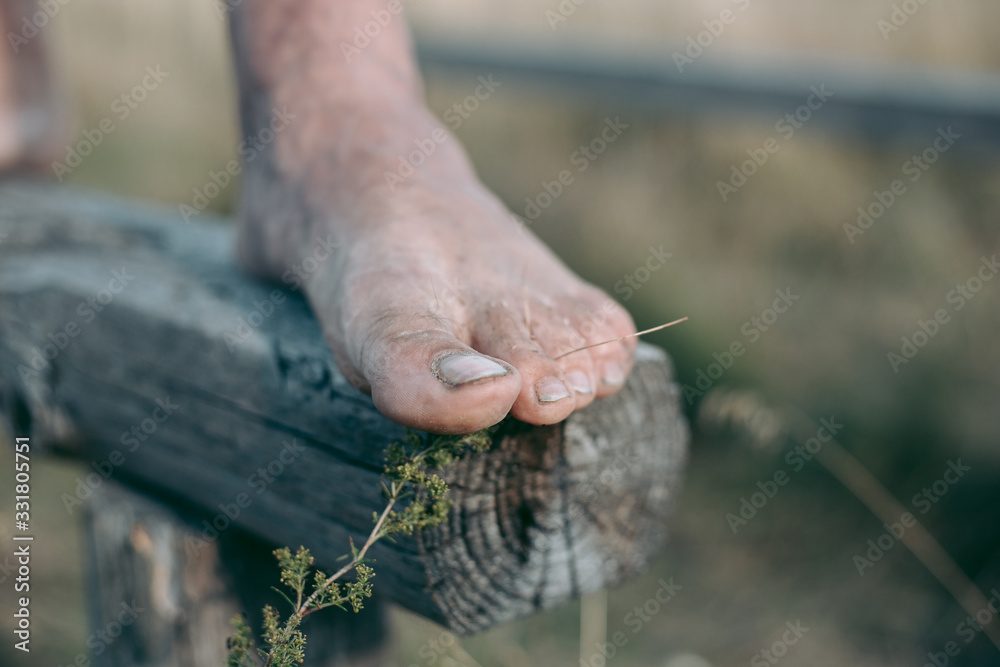 Man barefoot on the log in daylight