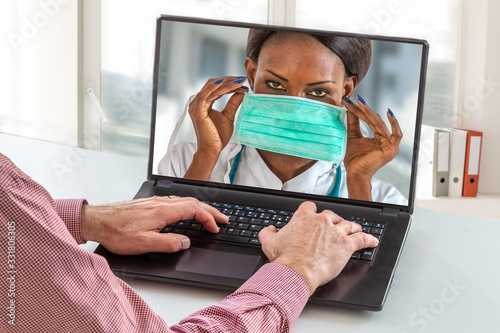 Virology protective concept. Close up of senior man sit at home having online consultation with female nurse on how using proctective mask photo