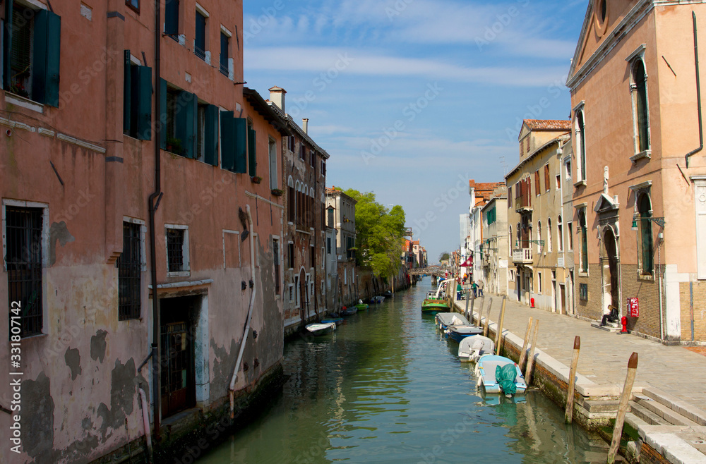 Traditional Venice Cityscape with narrow canal, gondola