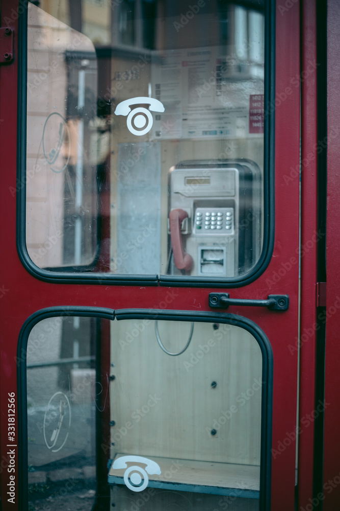 Old red telephone box in the city