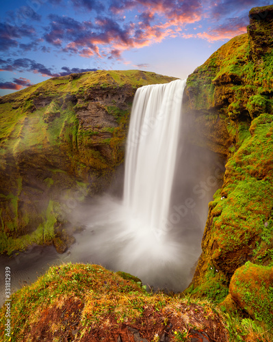 Panoramic view of Skogafoss waterfall on the Skoga river  a popular tourist attraction and part of the Golden Circle Tourist Route. Famous landmark of Iceland  Europe. Travelling concept background.