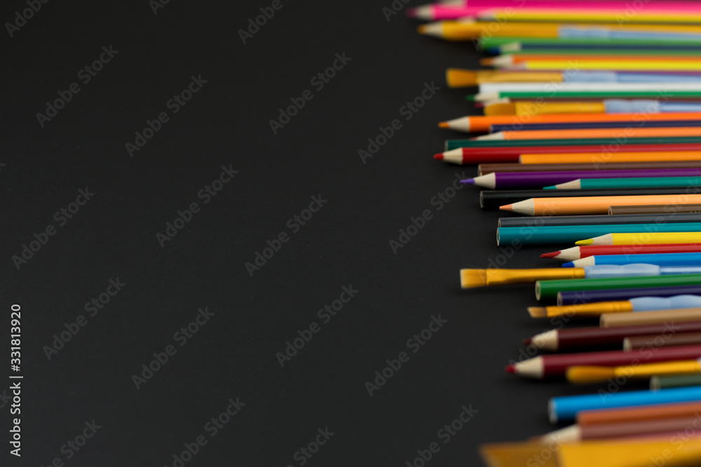 Top view with copy space. Coloured pencils on black background. Concept of Art, Advertisment template, comcept of creative education. Top view with copy space. Coloured pencils on black background. Concept of Art, Advertisment template, comcept of creative education.