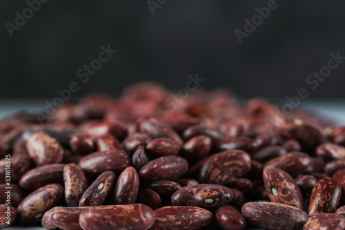 Fresh and healthy red beans on black background