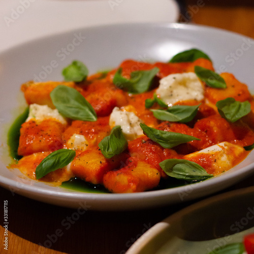 Tomato gnocchi with cheese and basil