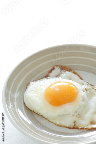 homemade  sunny side up fried egg on dish