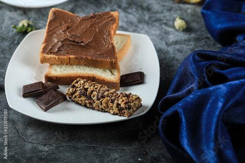 Chocolate bread toast with chocolate pieces in a white saucer