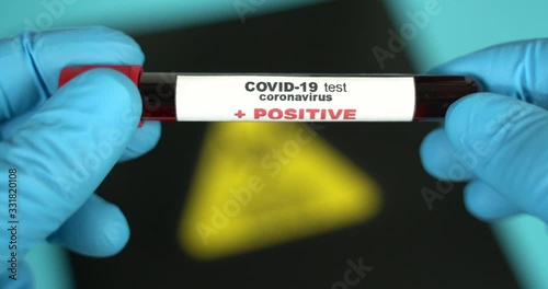 Doctor holds COVID 19 Coronavirus vaccine in his hand, infected blood sample in the sample tube, Vaccine and syringe injection It use for prevention, immunization and treatment from COVID-19