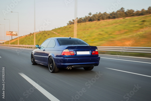 Black business class car on the highway in the sunset, red xenon lights  © azerbaijan-stockers
