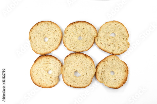 Bake rolls. Mini bread chips isolated on white background. Round bread slices.