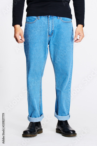 Male model in blue jeans bottom on white background.