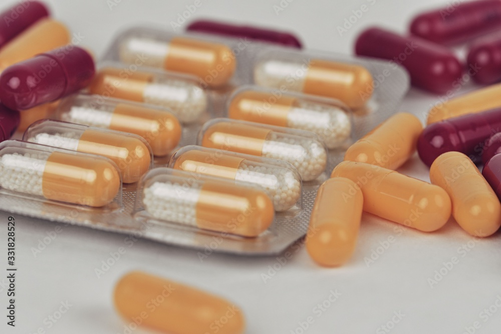 Colorful of capsules pill in blister packaging arranged with flare light. Pharmaceutical industry concept. Pharmacy drugstore. Antibiotic drug resistance.