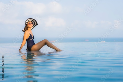 Portrait beautiful young asian woman relax around swimming pool in hotel resort