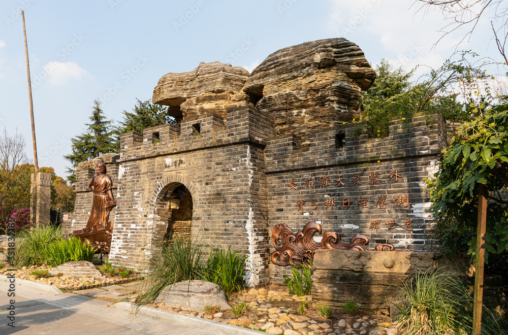 Rebuilt city wall & gate in Jiangwan Park at historic, old-town Jiangwanzhen, Hongkou, with sculpture of Han shizhong, patriotic general in Song dynasty & his poem.