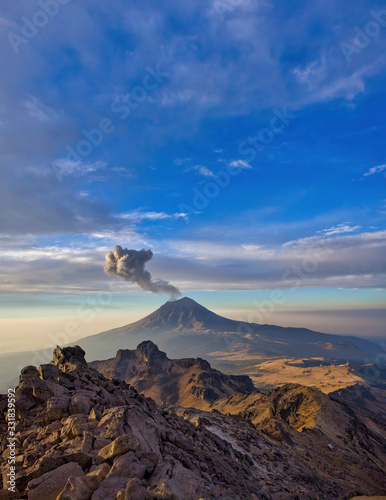 Climbing the Iztaccihuatl volcano, Popocatepetl volcano in Mexico, Tourist on the peak of high rocks. Sport and active life concept photo