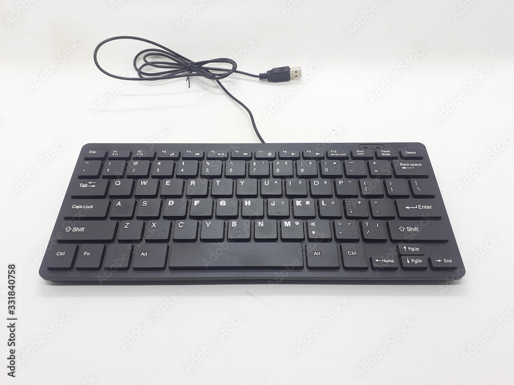 Small Minimalist Black Electronic Portable Keyboard for Computer Accessories Tools in White Isolated Background Small Minimalist Black Electronic Portable Keyboard for Computer Accessories Tools in White Isolated Background