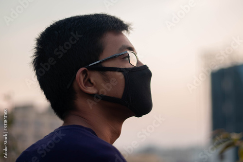 Spanish boy wears a black safety mask.Mask prevents corona virus and air pollution dust.New type coronavirus 2019-nCoV pneumonia in Wuhan has been spreading into many Countries
