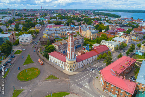 Old fire tower in the cityscape on a sunny July day (aerial photography). Rybinsk, Russia