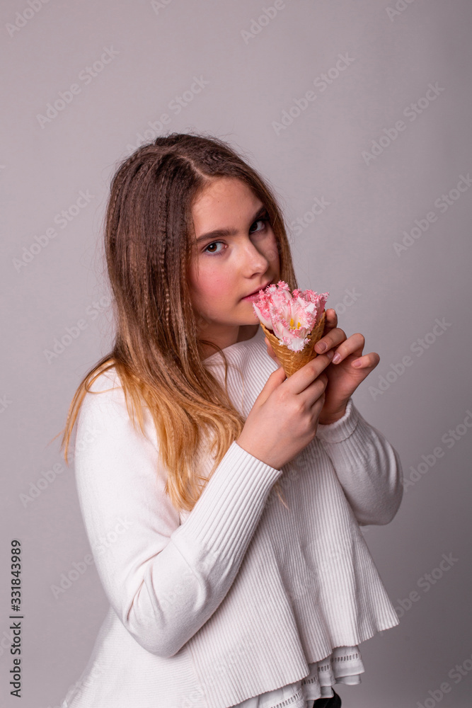 vertical portrait of a pretty teenager girl who eats flowers ice cream vertical portrait of a pretty teenager girl who eats flowers ice cream