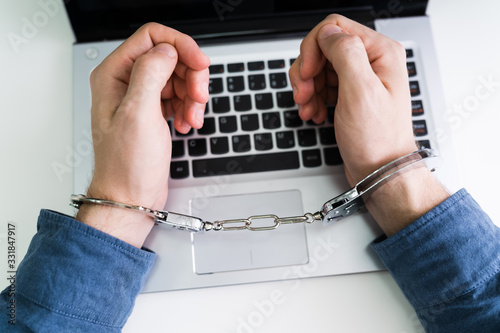 Person With Handcuff Using Laptop