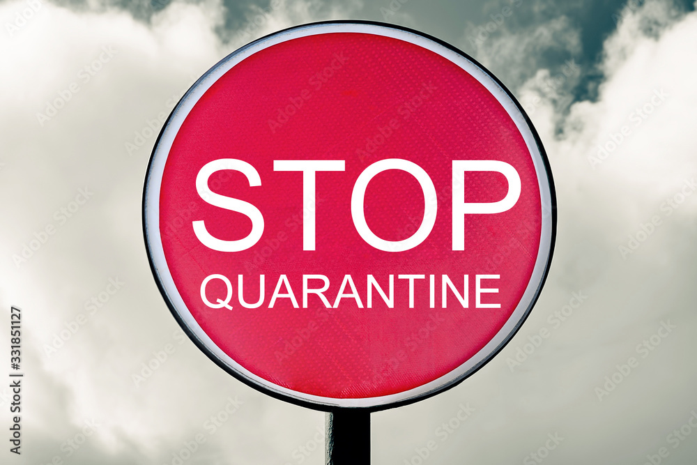 Obraz premium The concept of a pandemic. STOP sign on the background of a cloudy sky with clouds tinted in red. Quarantine prevention of coronavirus disease COVID-19