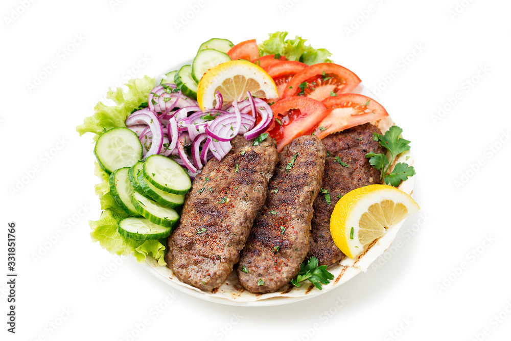 Grilled meat kebabs (cutlets) served with vegetables and tortilla, flatbread. isolated on white background Grilled meat kebabs (cutlets) served with vegetables and tortilla, flatbread. isolated on white background
