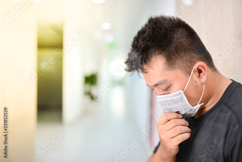 Asian man wearing medical mask at office. Wuhan China coronavirus (COVID-19) outbreak prevention. Health care and medical concept. Protection against virus, infection, exhaust.
