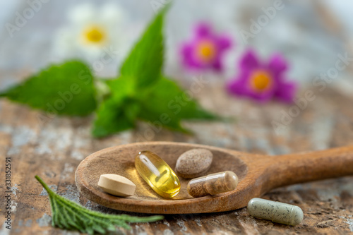 Obraz na plátně Wooden spoon of food suplements healthy medicine medication health care treatmen