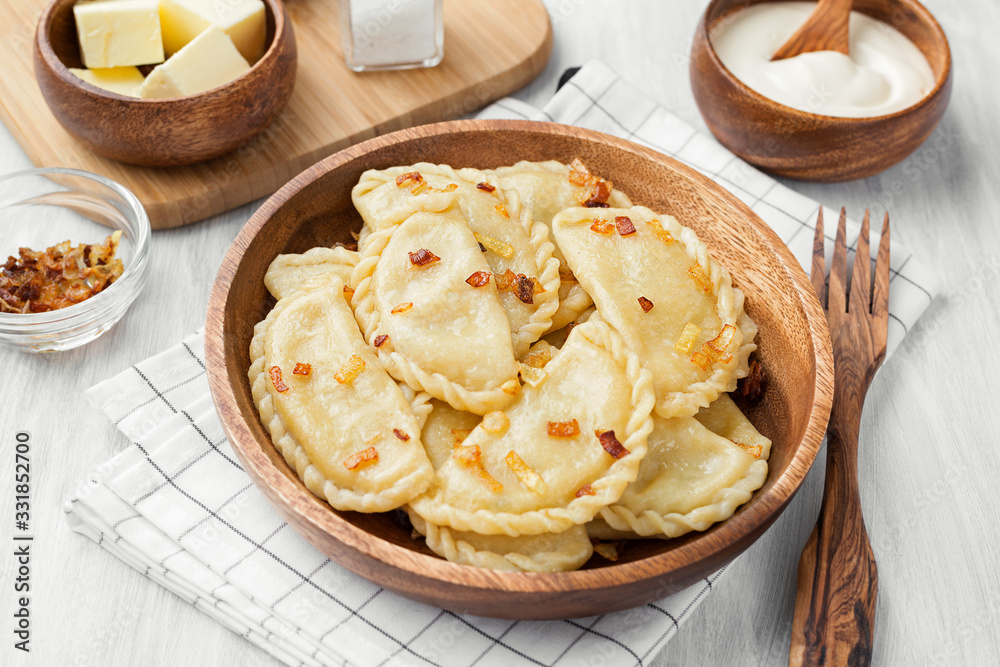 Dumplings, filled with mashed potato served with fried onion and sour cream. Dumplings, filled with mashed potato served with fried onion and sour cream.