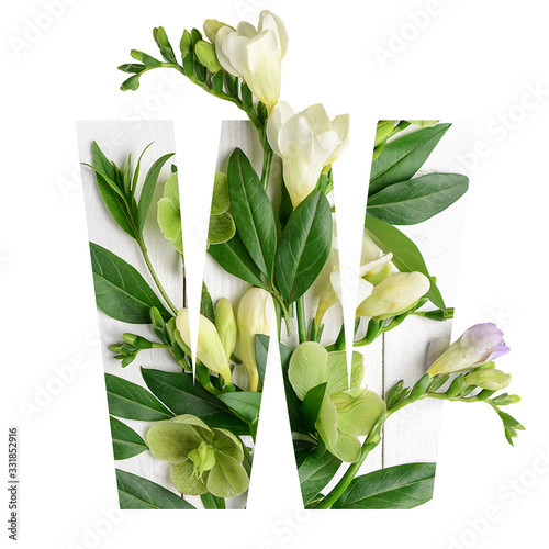 Letter W made of beautiful flowers on white background