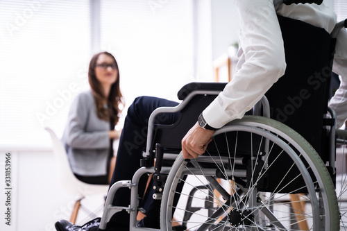 Disabled Businesswoman Sitting On Wheelchair