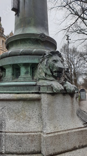 Lion barillef on the background of a city park. Sweden photo