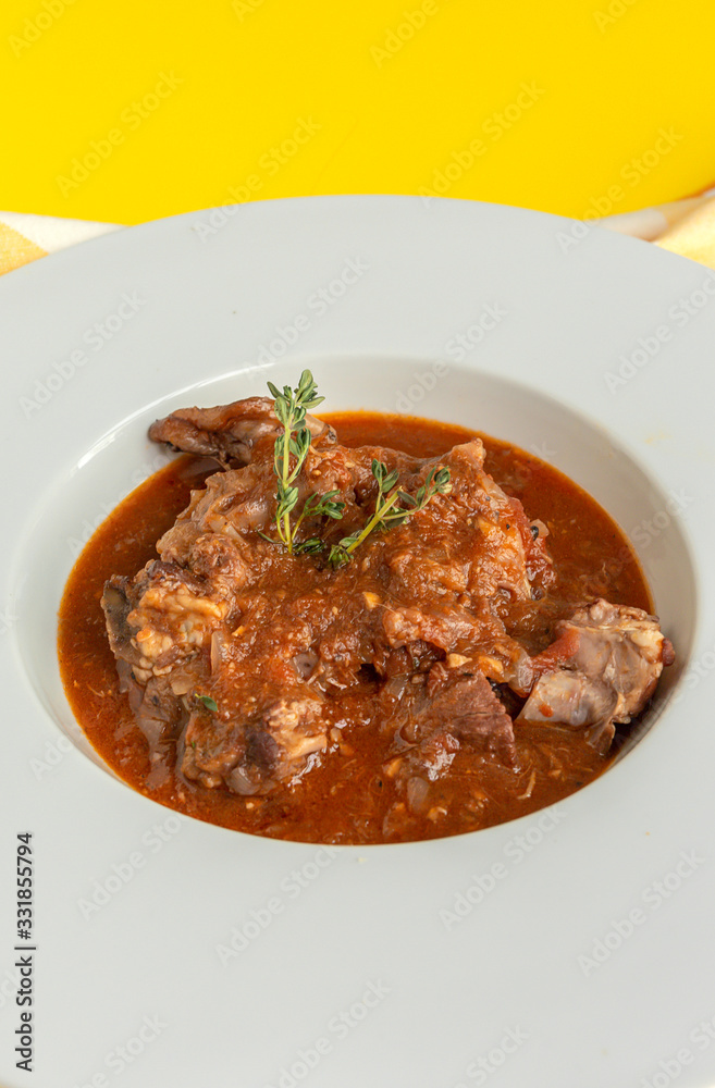 Lamb stew with aromatic herbs seen from above Lamb stew with aromatic herbs seen from above