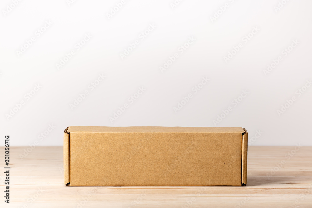 cardboard box on wooden table cardboard box on wooden table