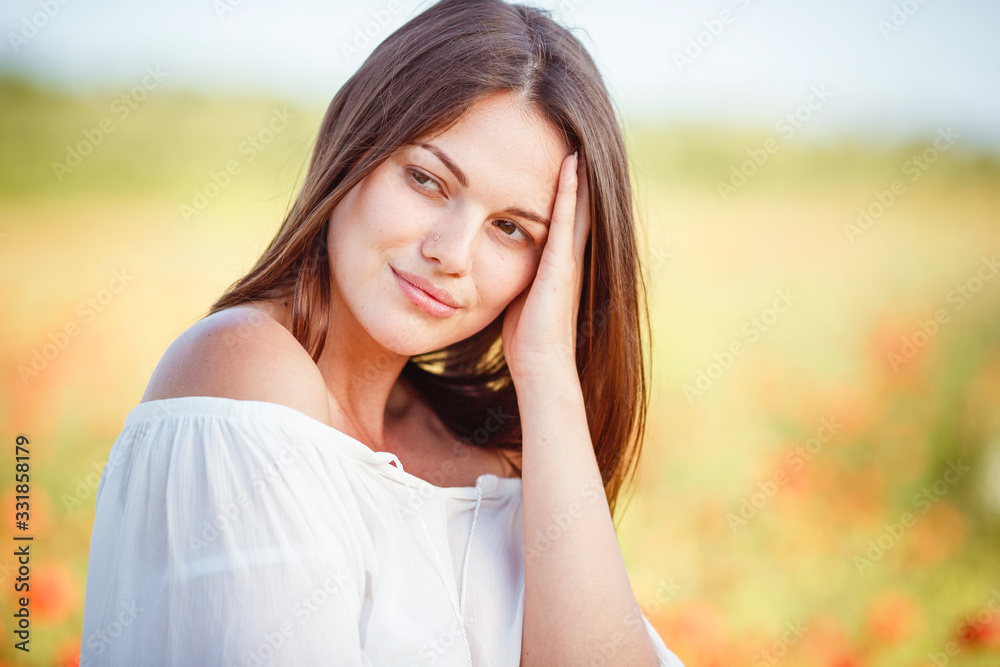young beautiful woman walking through a poppy field young beautiful woman walking through a poppy field