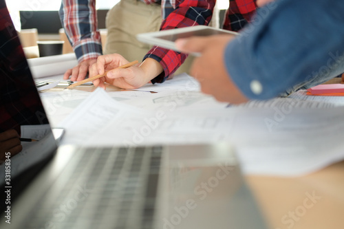 architect engineer team working discussing on house blueprint of real estate project in meeting photo