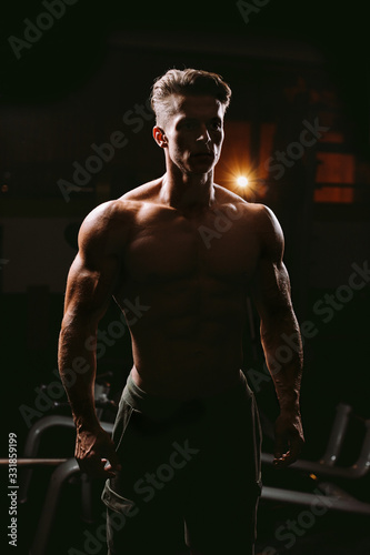 silhouette of muscular man in gym