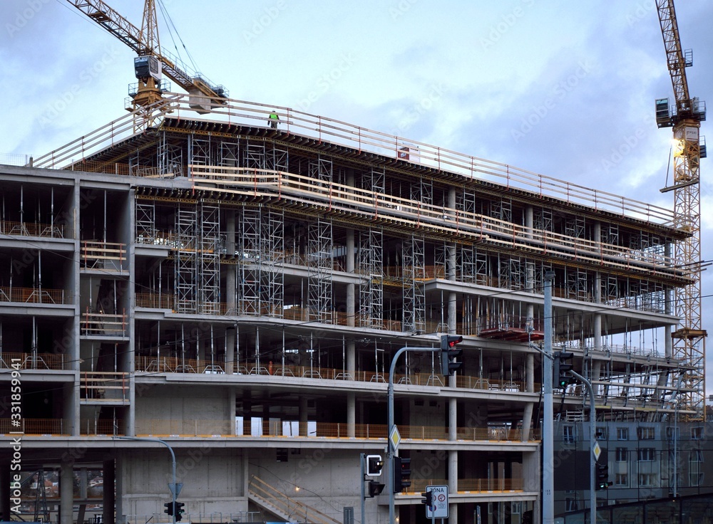 Cranes build houses in Prague