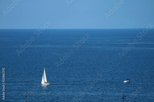 Aerial view of white sailboats on the blue sea with copy space © jobi_pro