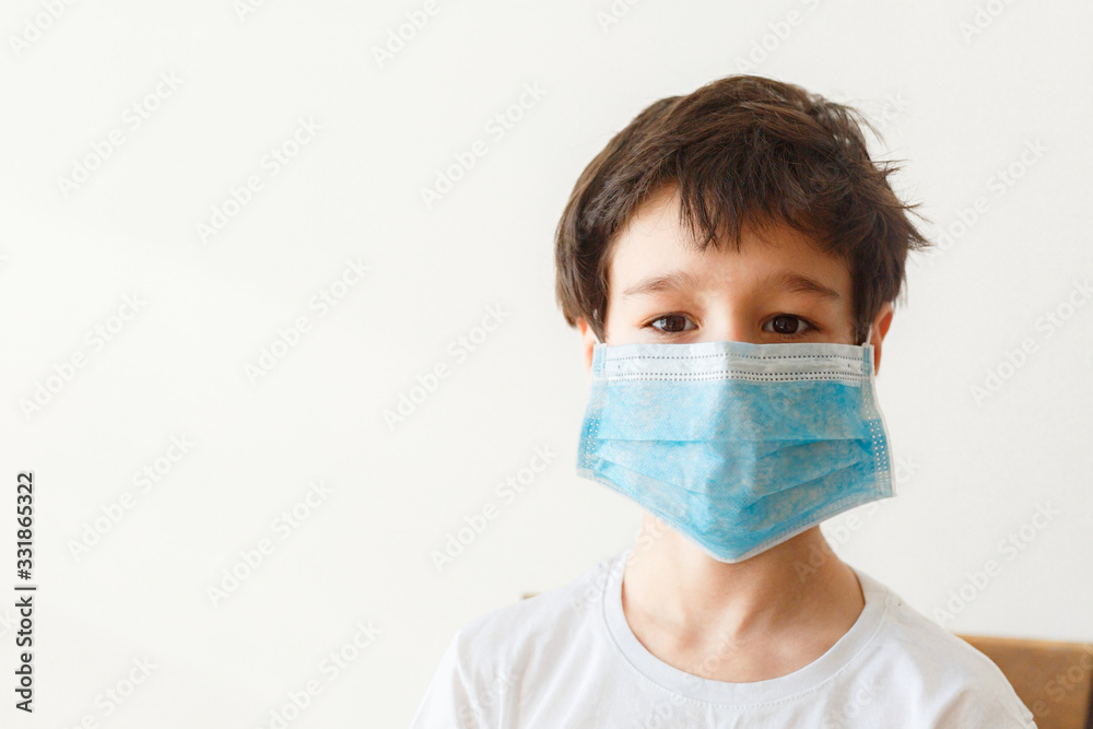 Cute little asian boy wearing health mask, looking up, isolated over white background Cute little asian boy wearing health mask, looking up, isolated over white background