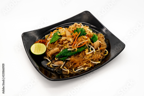 Stir fried rice vermicelli noodle with chicken on white background.