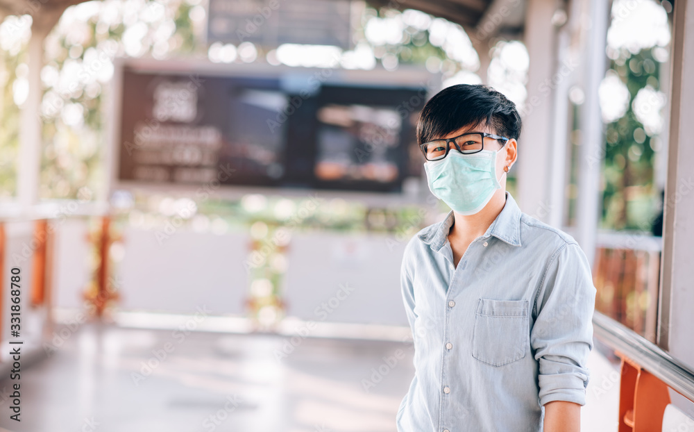 Adult Asian Woman Short Hair in Casual Jeans Shirt Standing at Walking Way. She Wearing Virus Protective Mask in Prevention for Coronavirus or Covid-19 Outbreak Situation - Healthcare and Lifestyle