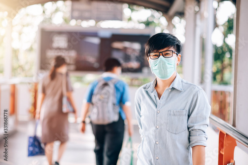 Adult Asian Woman Short Hair in Casual Jeans Shirt Standing at Walking Way. She Wearing Virus Protective Mask in Prevention for Coronavirus or Covid-19 Outbreak Situation - Healthcare and Lifestyle © Platoo Studio
