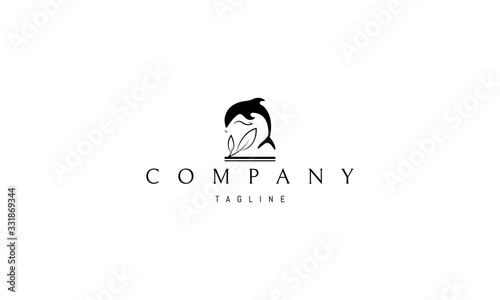 Vector black logo on which an abstract image of a jumping dolphin and two leaves.