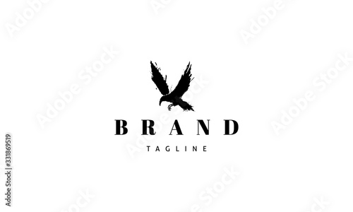 Vector logo on which an abstract image of a flying gloomy crow.