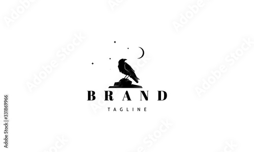 Vector logo on which an abstract image of a raven sitting on a stone under the moon.