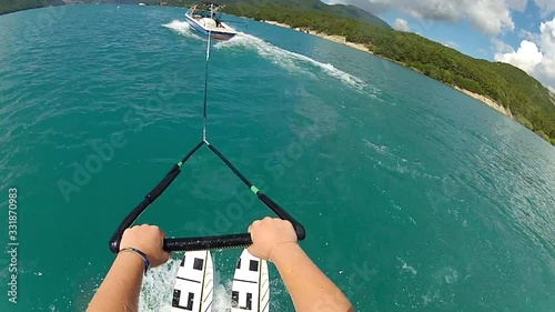 POV view of waterskiing. Water ski action camera, hands hold rope.